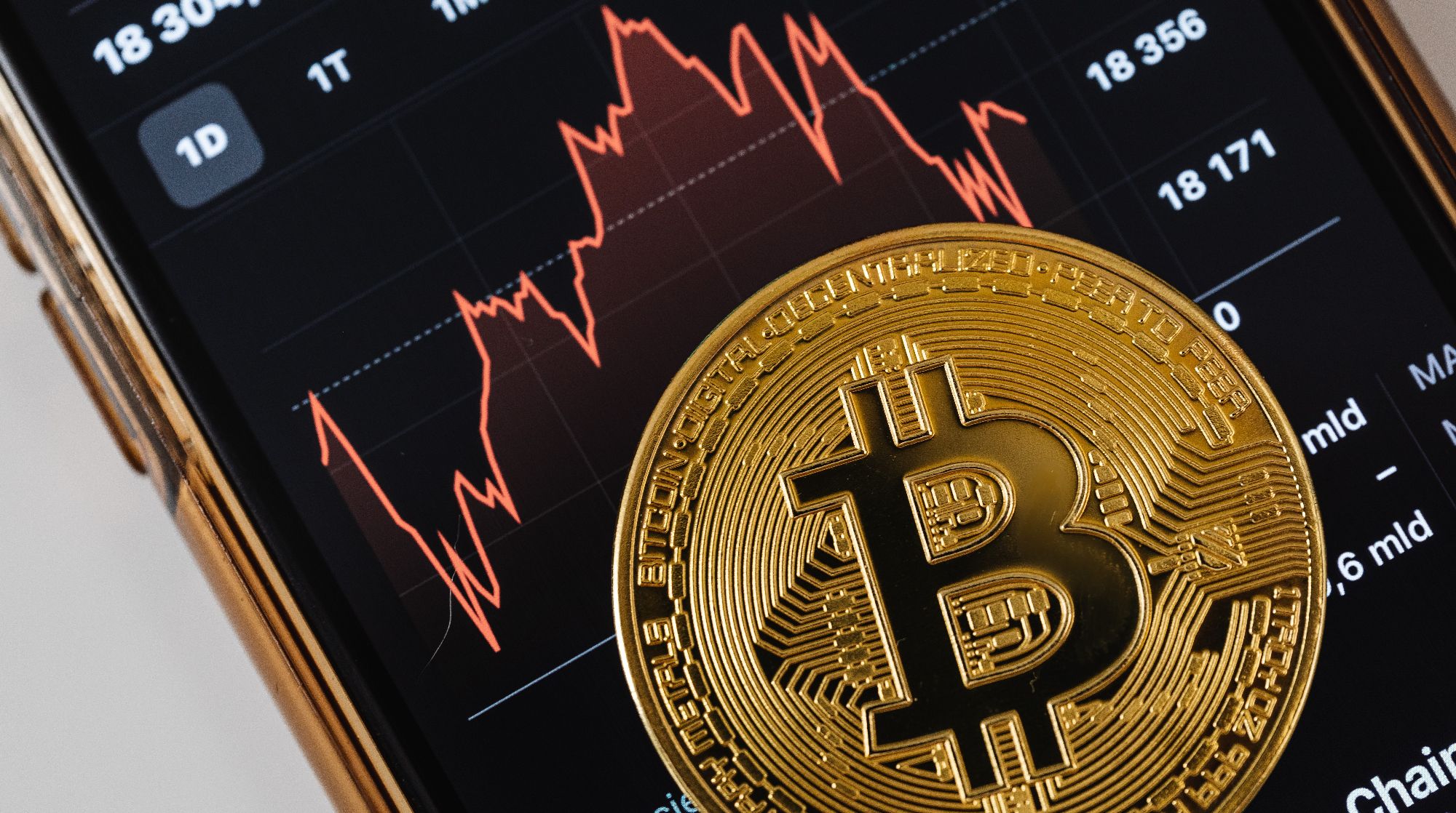 bitcoin de oro en la parte superior del gráfico de precios en el teléfono inteligente