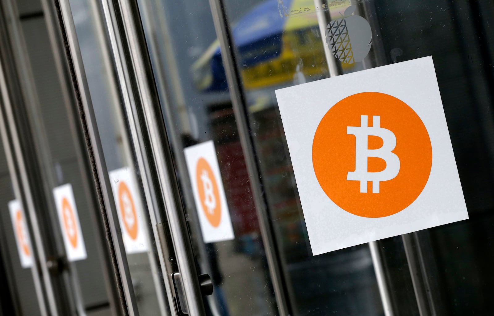 ARCHIVO - Los logotipos de Bitcoin se muestran en la conferencia y feria comercial Inside Bitcoins el 7 de abril de 2014 en Nueva York. (Foto AP/Mark Lennihan, Archivo)